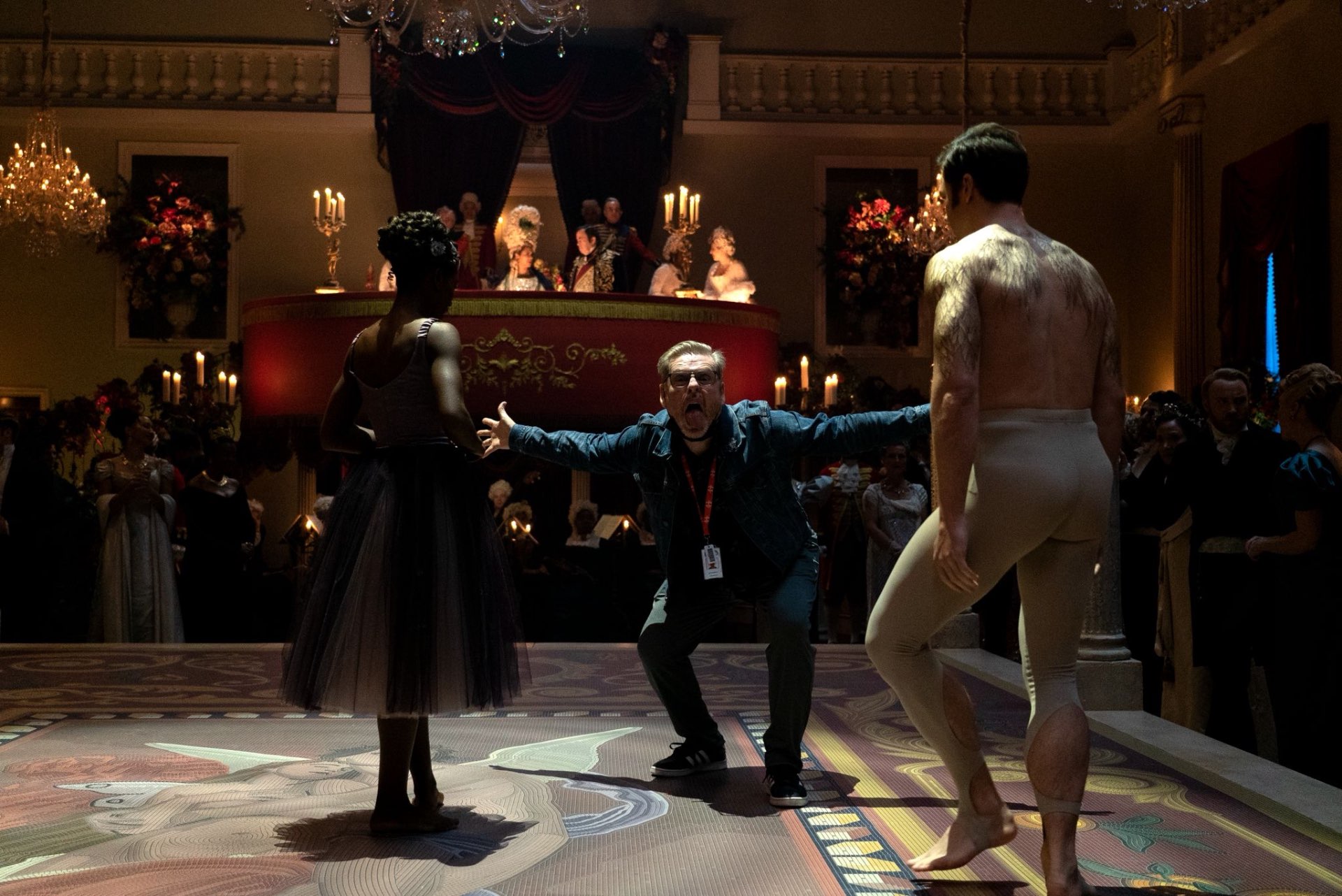 Jack Murphy directing dancers on a Bridgerton ballroom set